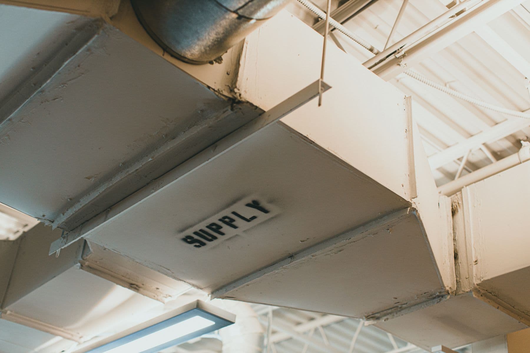 Industrial supply ductwork in a commercial kitchen ceiling